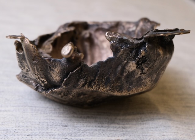 Cabbage Bowl, bronze a bowl made by casting cabbage leaves in bronze. Some of the flashing remains, extending the leaves