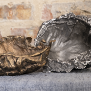 a bronze bowl and an aluminum bowl, both made from cabbage leaves, the bronze bowl is a little smaller