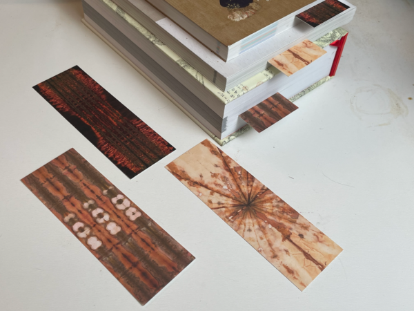 three chromatogram bookmarks with a stack of books